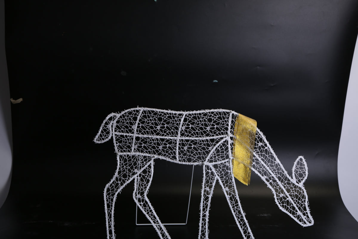Reindeer family lit at night